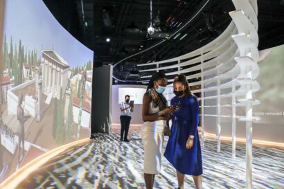 Two women holding ipad using Benaki Augmented Reality app in the Dubai World Expo 2020