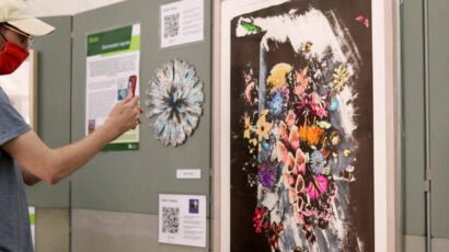 Person looking at Alex Hirtzel paintings through Augmented Reality filter