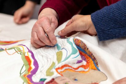 Handmade stitching the spirit heads tapestry, Zubr Highland digital project AR, High life Highland, digital tapestry