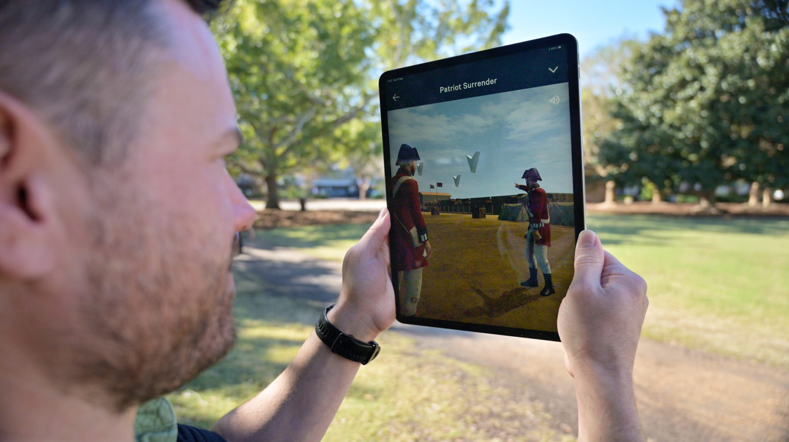 Person using Liberty Trail AR app on an ipad, in Marion Square, Charleston