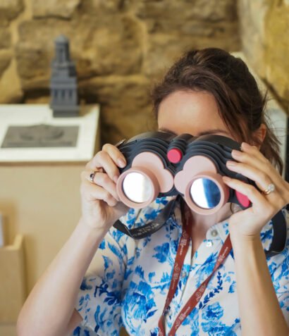 Woman looking through AR binoculars for Beckford's Tower, 360 degrees, AR landmark labels, Beckford's Tower, AR for heritage, AR for museums, Zubr, AR trail, AR app, AR tower viewer, VR tower viewer. Bath AR Trail