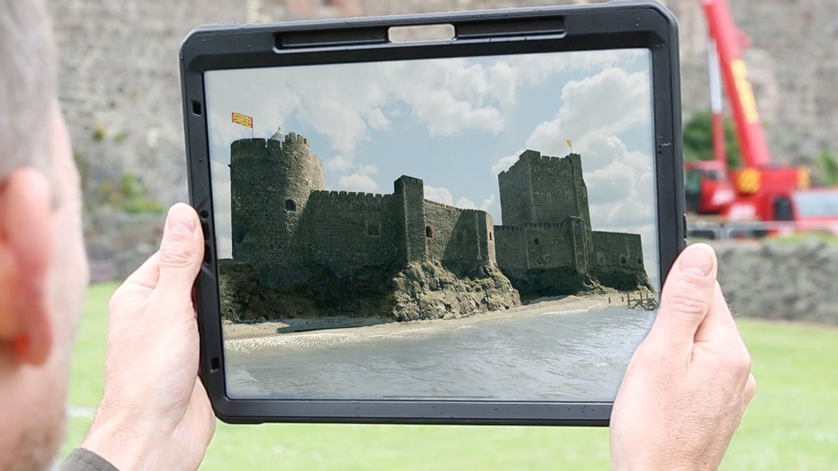 Person using AR (Augmented Reality app) for Carrickfergus Castle