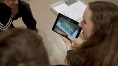 Group of students holding ipad using the Making a Scene app, an AR theatre careers app for a mixed reality educational loan box for University of Bristol Theatre Collection and Bristol Old Vic.