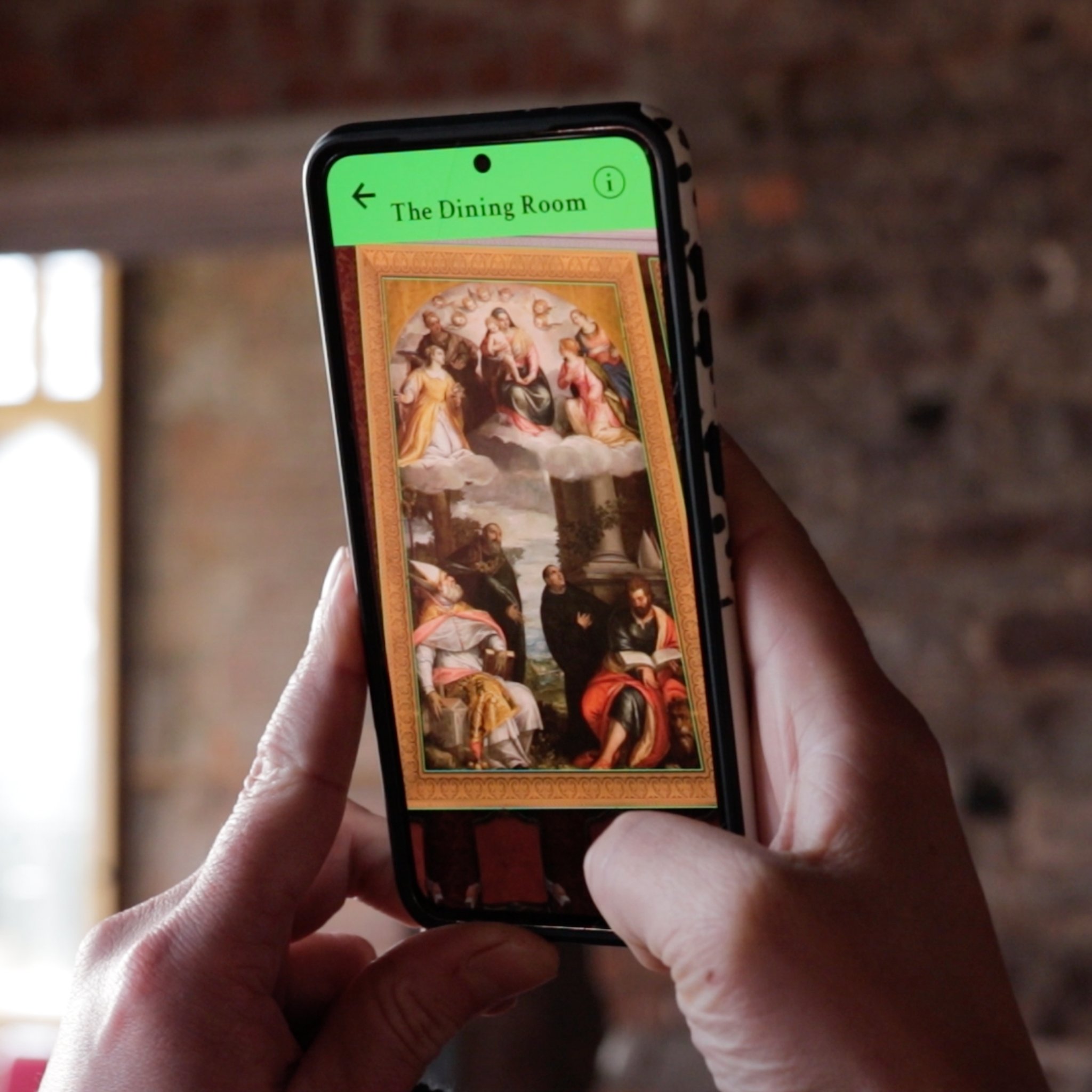 Phone showing 3d digital AR dining room from Margam Castle augmented reality app