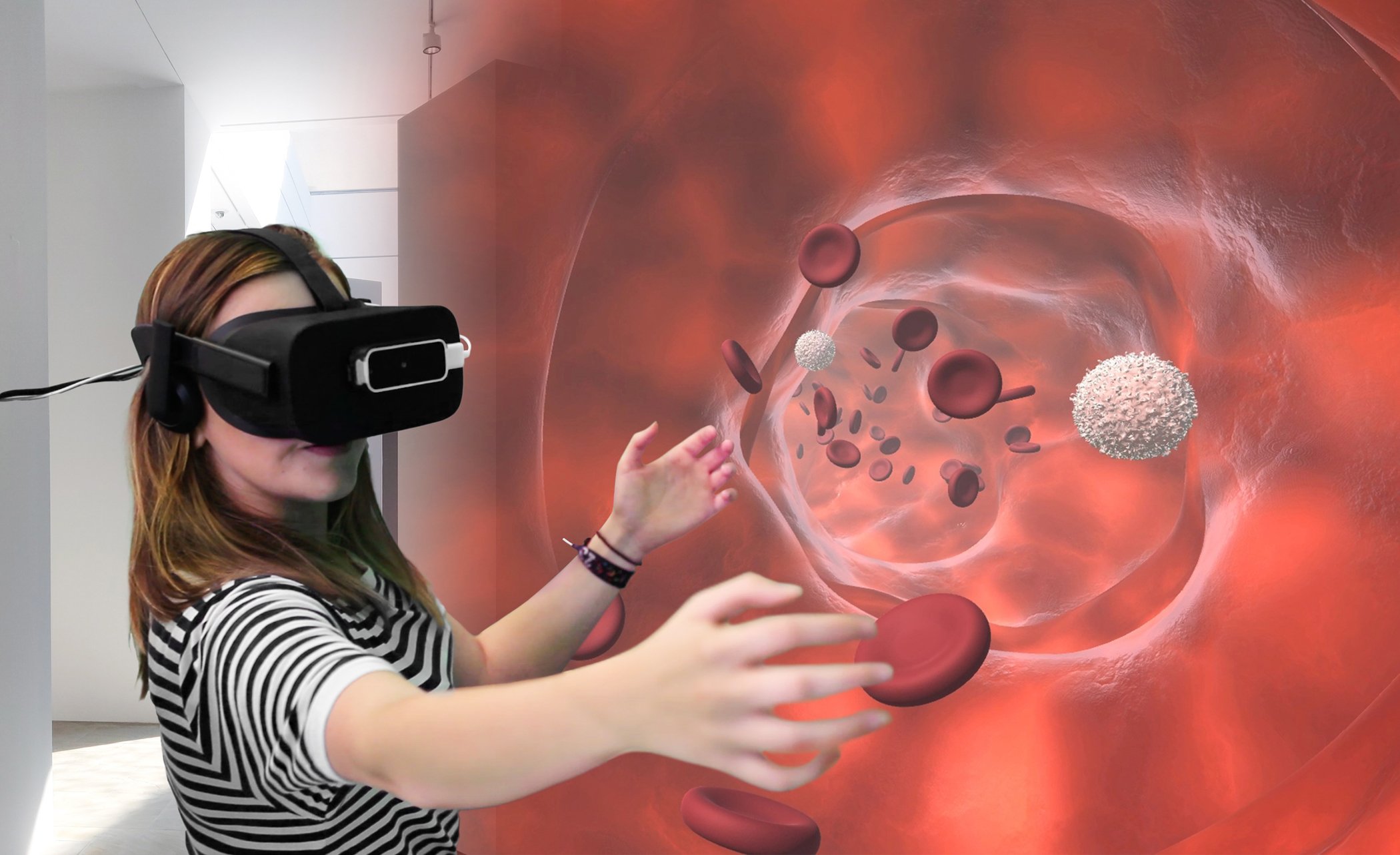 Woman with Virtual reality headset viewing blood cell stream at a pharmaceutical trade show