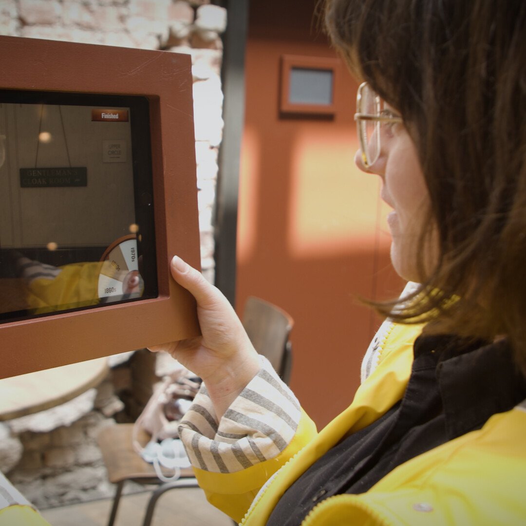 Girl with ipad using the Window to the Past Augmented Reality (AR) app made for Bristol Old Vic theatre