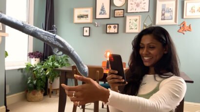 Person using the augmented Reality Benaki artefact app viewing old gun in AR