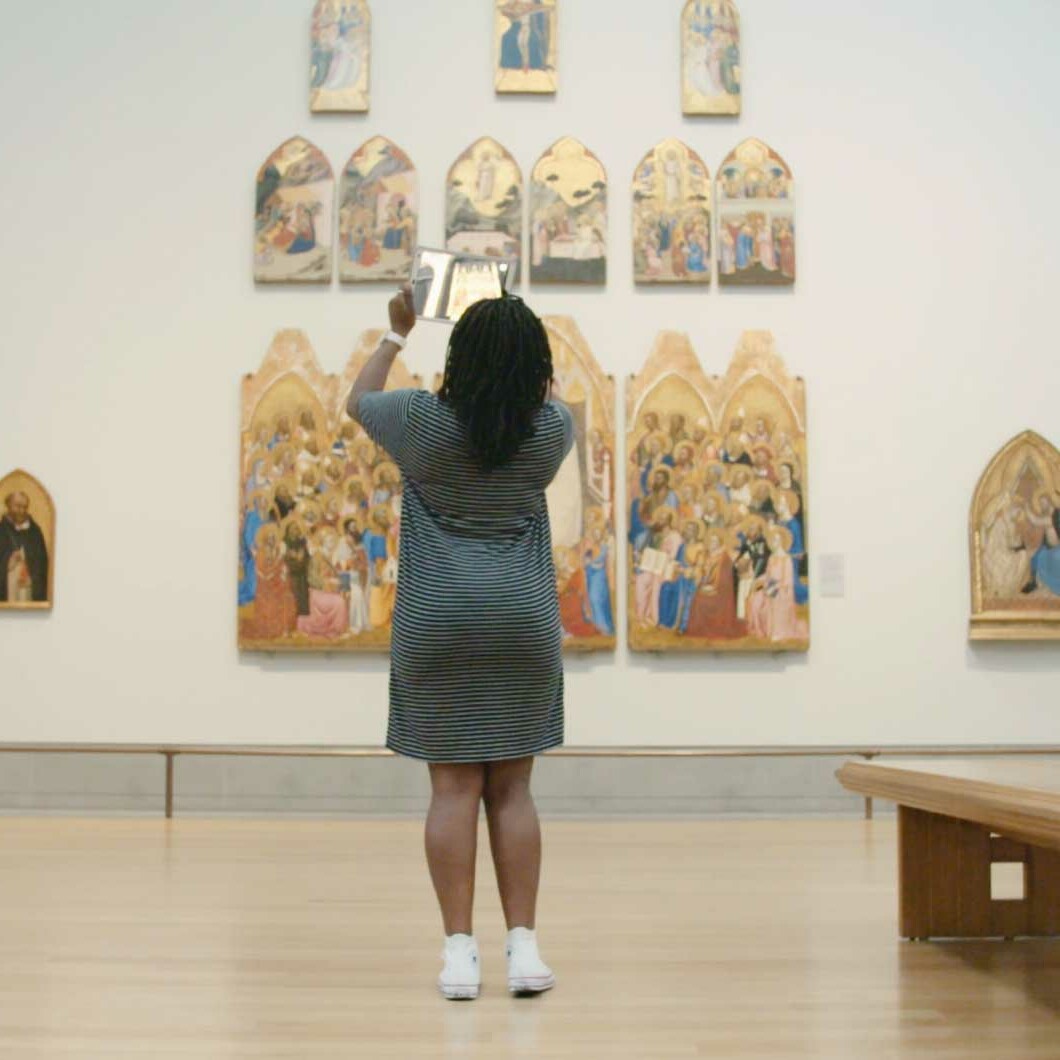 Woman in London National Gallery using augmented reality Hidden Florence app. national gallery augmented reality app