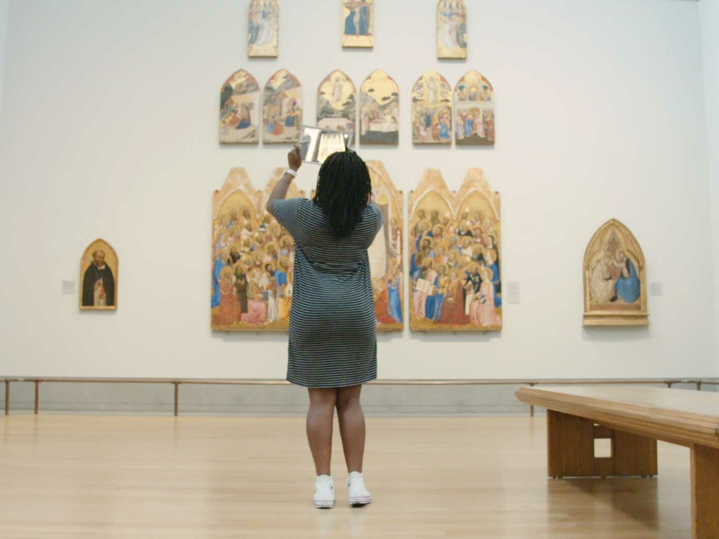 Woman in London National Gallery using augmented reality Hidden Florence app. national gallery augmented reality app