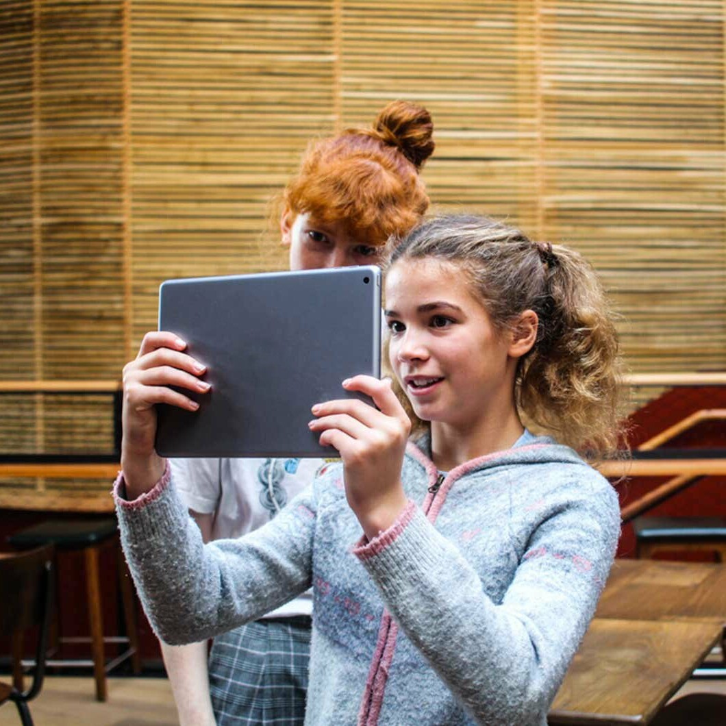 Two girls trying the Window to the past Augmented reality app for Bristol Old Vic. augmented reality history tour