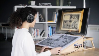 Person reading AR book, Unlocking The Cage. Archival access AR, Zubr AR, accessible cultural heritage and history, female authors