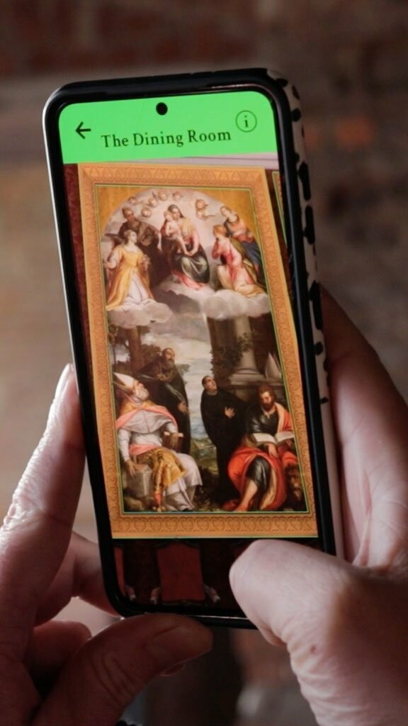 Phone showing 3d digital AR dining room from Margam Castle augmented reality app