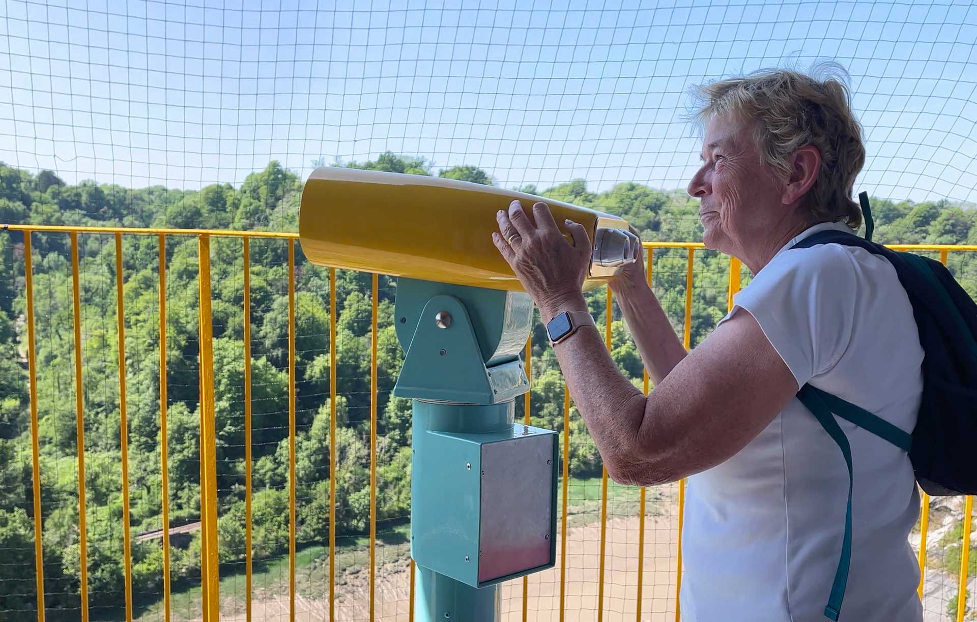 Woman looking through Augmented reality (AR) binoculars at Bristol Observatory Giant's Cave