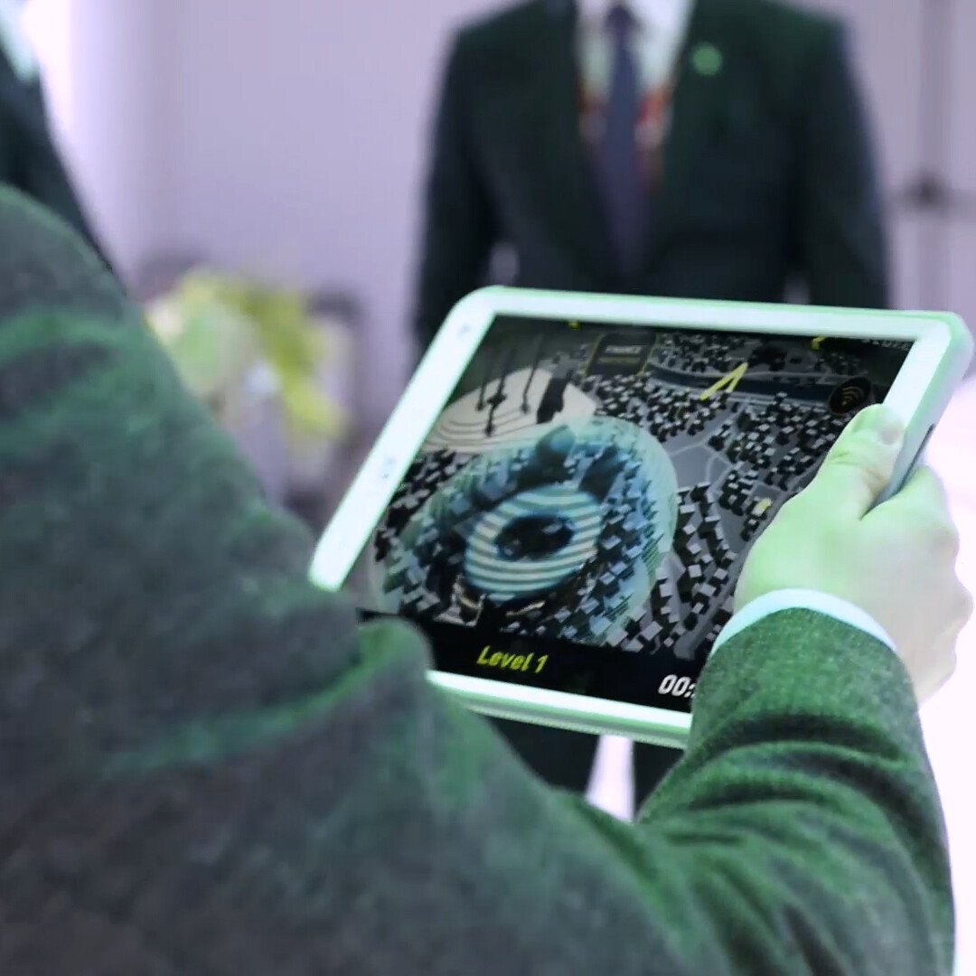 Person trying Cyber security AR city game in an iPad