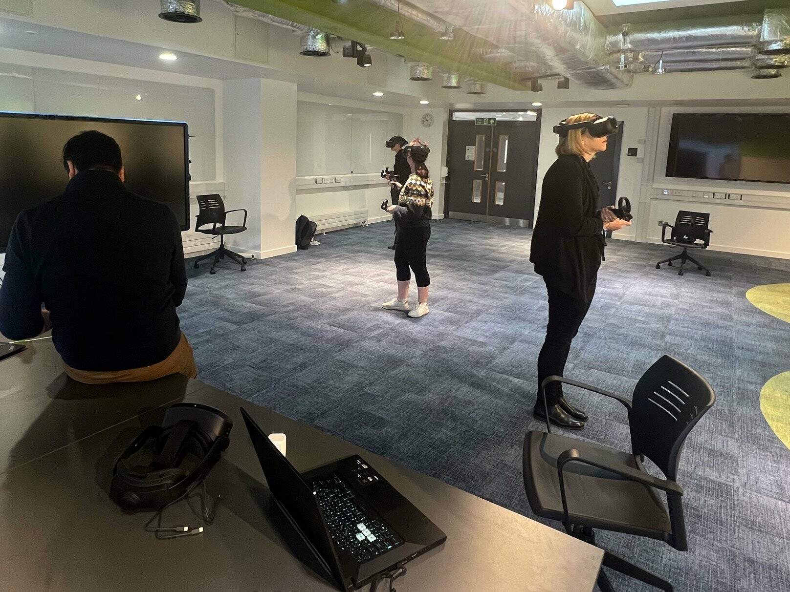 Students doing a Virtual reality (VR) cybersecurity training at Belfast Queen's University