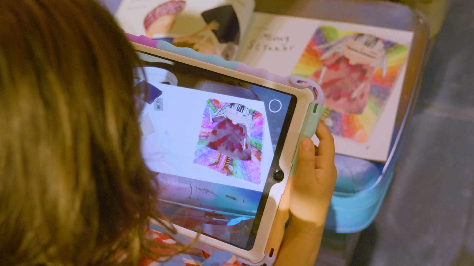 Child trying augmented Reality book Minny Stynker. AR Books tested by children