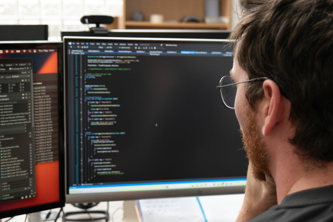 Zubr team member coding at their computer